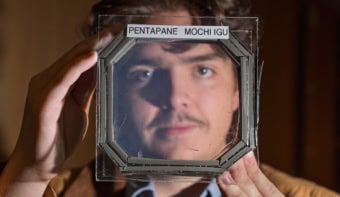 Photograph of a person peering through a window that contains the new aerogel material