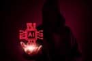 silhouette of figure in a hoodie holding a glowing red AI chip