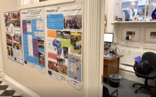 Row of 3 posters on a wall next to an open office door