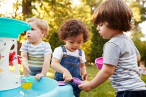 Children playing with water in a garden