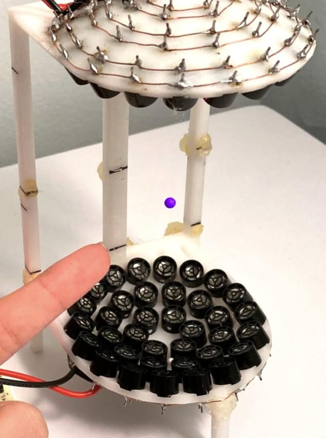 Photograph of a particle being help in acoustic tweezers