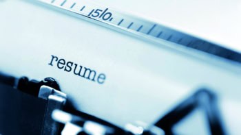 Typing a resume on an old fashioned typewriter