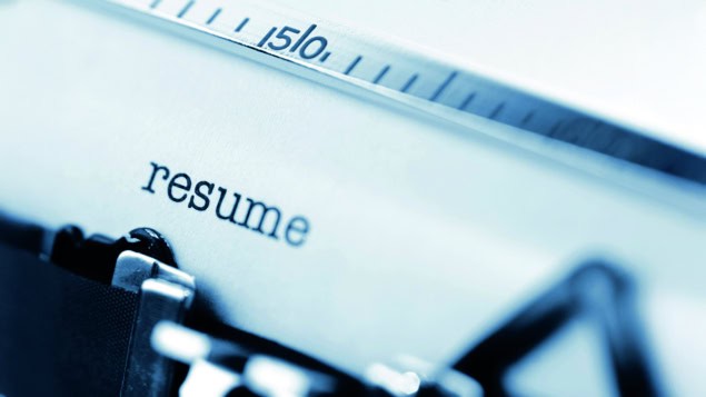 Typing a resume on an old fashioned typewriter