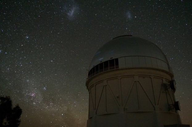 Photo of the Blanco telescope dome against a starry night sky