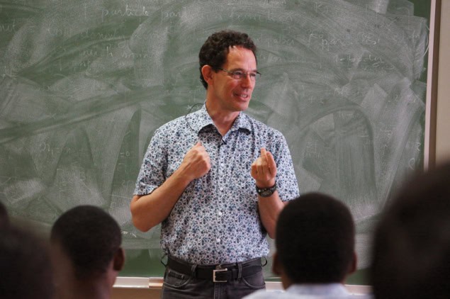 Man in front of a blackboard with students