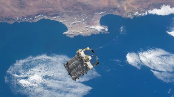 An external pallet packed with old nickel-hydrogen batteries is pictured shortly after mission controllers in Houston commanded the Canadarm2 robotic arm to release it into space