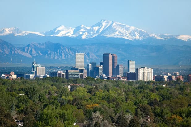 Aerial photo of downtown Denver, Colorado, with the Rocky Mountains beyond