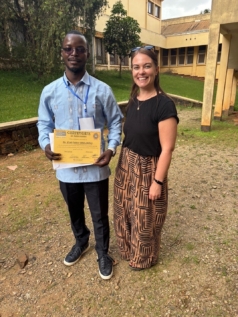 Photo of two people stood outside a university building