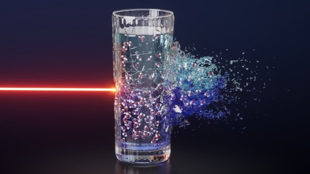 Conceptual image showing a bright neon red laser beam striking a glass of water. Inside the water glass are little ball-and-stick models of water molecules. The glass is divided into dark and light blue regions, representing the two liquid phases of supercooled water. On the side of the glass opposite the laser beam, the water is bursting outward.