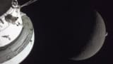Orion module in foreground with the Moon behind and then in the far distance a crescent of Earth
