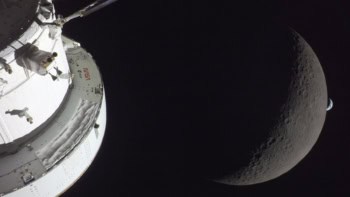 Orion module in foreground with the Moon behind and then in the far distance a crescent of Earth