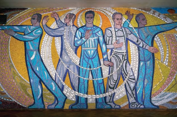 A mosaic depicting five scientists on the wall of a science facility