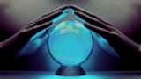 A pair of male hands surrounding a crystal ball