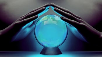A pair of male hands surrounding a crystal ball