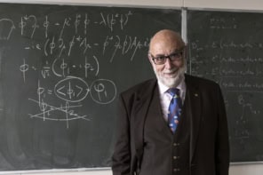 François Englert standing by a blackboard