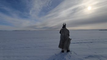 Artist Tom Bailey trekking in the Arctic with reindeer antlers