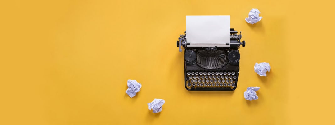 vintage typewriter and scrunched up papers