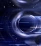 Artist's impression of the region of space around a black hole's event horizon. A doughnut-shaped region of space warps and blurs the starry black background