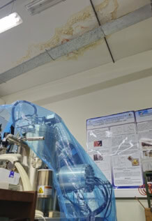 covered microscope and leaky ceiling in lab in argentina