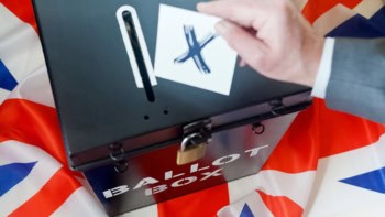 Photo of someone casting a ballot