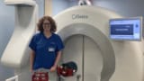 Photo of Katherine Hunt in front of a Gamma Knife facility