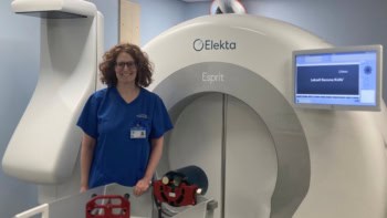 Photo of Katherine Hunt in front of a Gamma Knife facility
