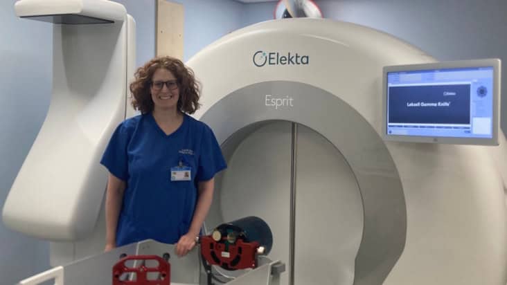 Photo of Katherine Hunt in front of a Gamma Knife facility