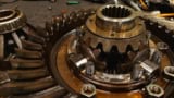 Close-up of truck rear differential and transmission parts, tools, maintenance, on the factory floor