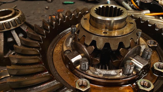 Close-up of truck rear differential and transmission parts, tools, maintenance, on the factory floor