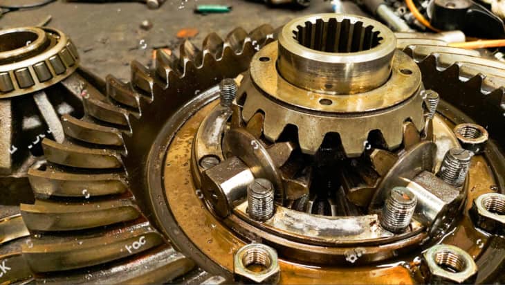 Close-up of truck rear differential and transmission parts, tools, maintenance, on the factory floor