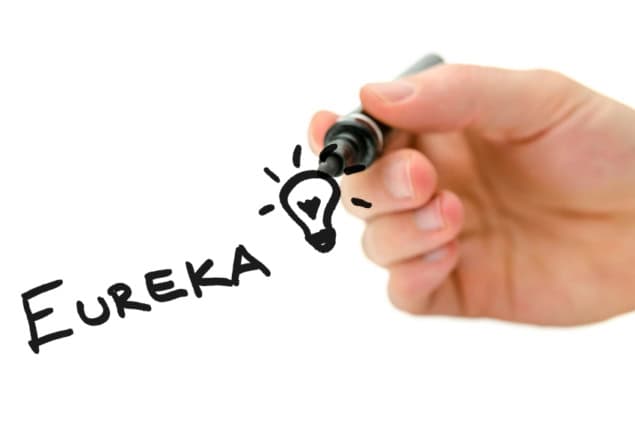 Male hand writing Eureka and light bulb on a virtual screen. Isolated over white background.